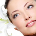 Healthy skin of beautiful woman face with a flower