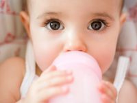 Baby girl drinking from bottle